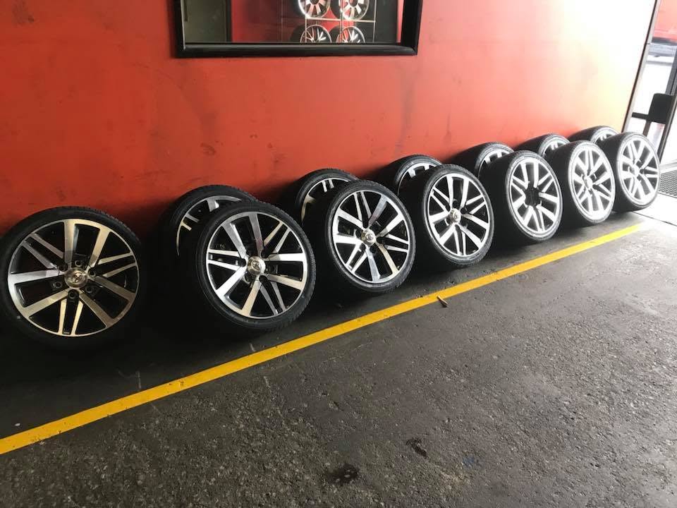 A row of wheels and tyres inside the Tyre Select workshop.
